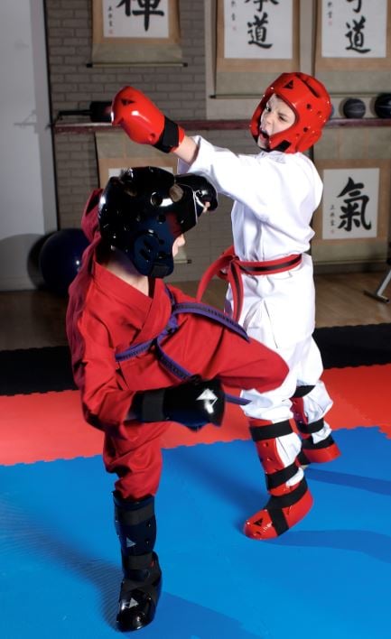 Children wearing Student Sparring Head Gear, Gloves, Boots and Shin Guards during training.